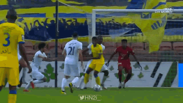 a soccer player with the number 21 on his jersey kicks the ball