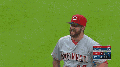 a baseball player wearing a red hat with the letter c on it is smiling