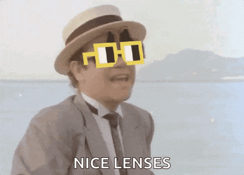a man wearing a hat and sunglasses says nice lenses .