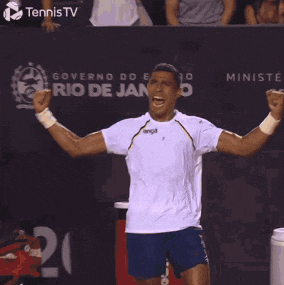 a tennis player stands in front of a sign that says tennis tv