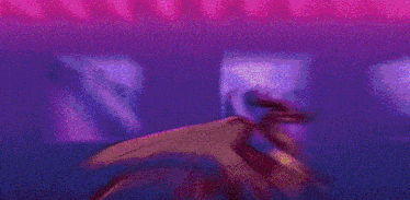 a couple of dragons standing next to each other in a room with a purple background .