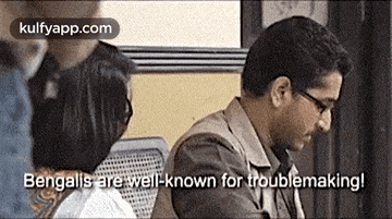 a man and a woman are sitting next to each other and the man is talking to the woman .