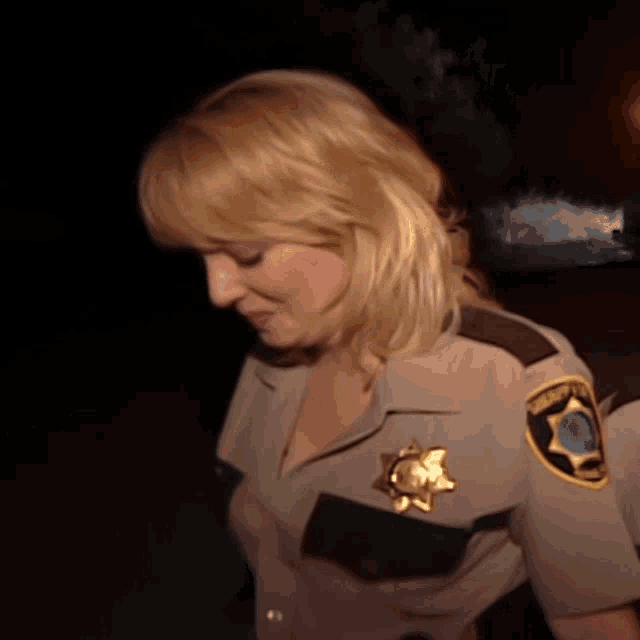 a woman in a sheriff 's uniform has a patch on her shoulder that says sheriff 's