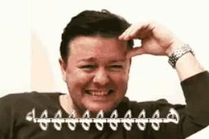 a man with braces on his teeth is laughing and smiling .