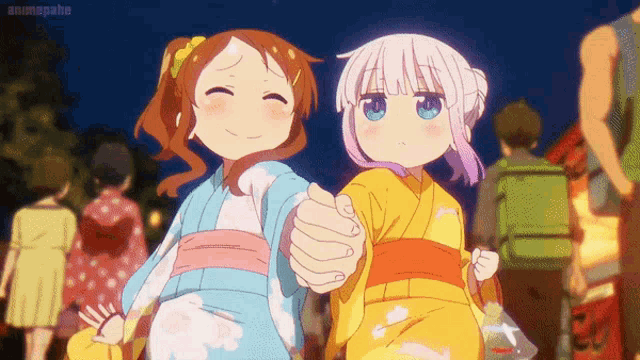 two anime girls in kimonos are holding hands and smiling at the camera .