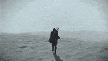 a black and white photo of a person standing in the middle of a desert