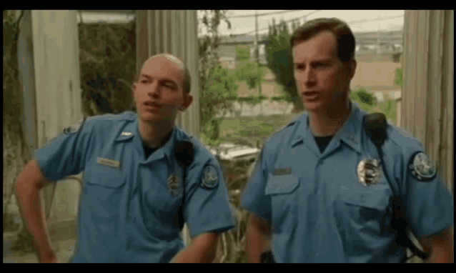 two police officers are standing next to each other and one of them has a patch on his chest that says ' a. '