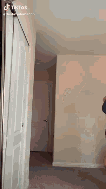 a person is standing in a hallway with a tiktok watermark on the bottom