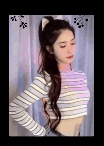 a woman is wearing a striped crop top and a cat ear headband