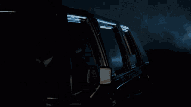 a man in a suit and tie is looking out of a car window with the words " привет даун " written below him