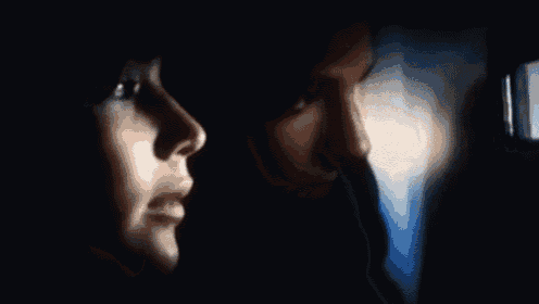 a man and a woman are looking at a screen together