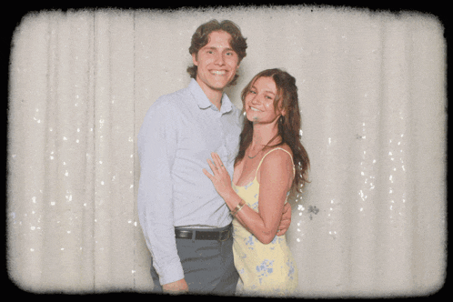 a man is carrying a woman in his arms and they are posing for a picture
