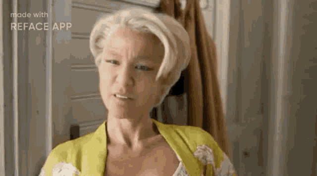 a woman with blonde hair is wearing a yellow robe and making a face .
