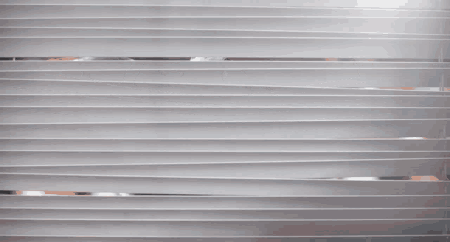 a cartoon character peeking through a window with blinds