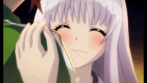 a close up of a person touching a girl 's face in a anime .