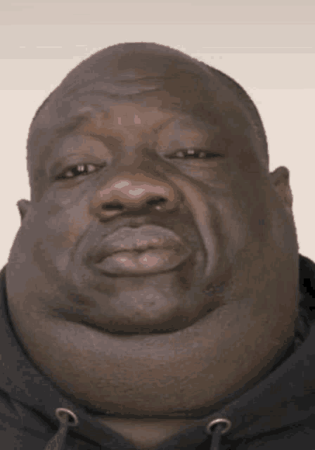 a man with a very large neck and a black hoodie