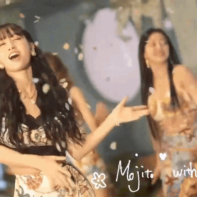 a woman in a floral dress is dancing in front of a sign that says mojito with flowers