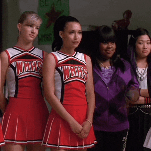 a group of cheerleaders wearing wmhs uniforms are standing next to each other