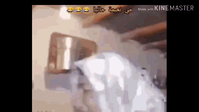 a man is standing in front of a window in a room with arabic writing .