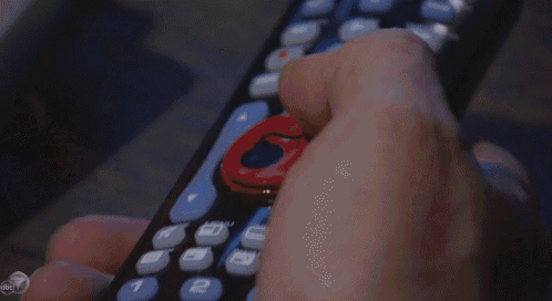a man sitting in front of a tv with a abc logo on his back
