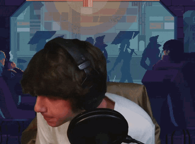 a man wearing headphones stands in front of a microphone in front of a pixel art background