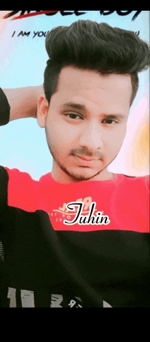 a young man in a red shirt with the name juhin on it