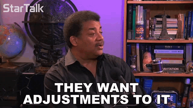 a man says they want adjustments to it while sitting in front of a bookshelf