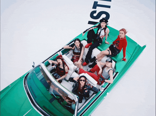 a group of women are sitting in a green car with the word lust written on the back