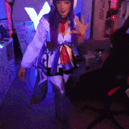 a woman with purple hair and a hat is standing in a dark room