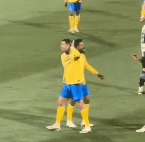 a group of men are playing soccer on a field .