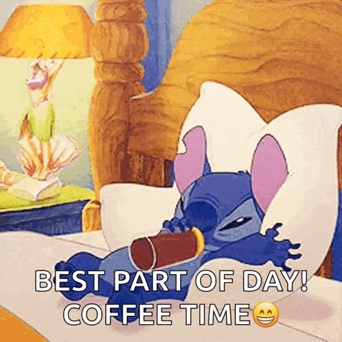 stitch is laying in bed with a cup of coffee