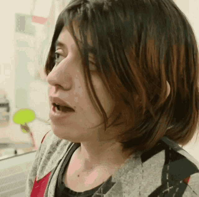 a close up of a woman 's face with her mouth open and her teeth missing