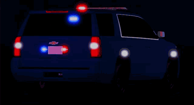 a blue chevrolet suv with red and blue lights on it