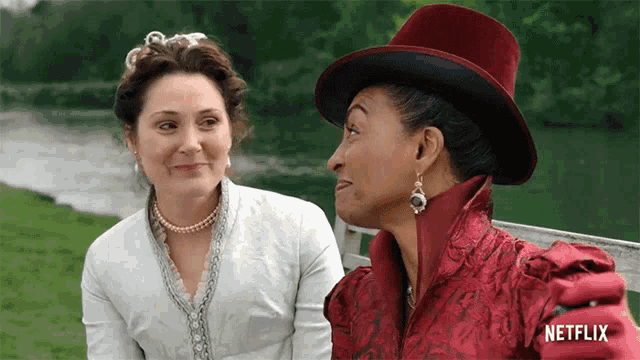 two women sitting on a bench with netflix written on the bottom right