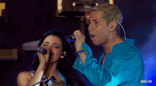 a man and a woman singing into microphones with the words rbd.gif below