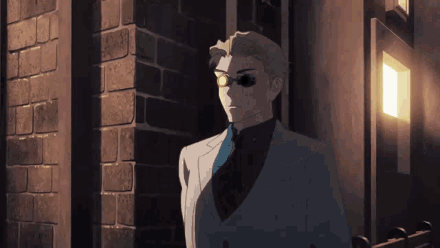 a man in a suit is standing in front of a brick wall