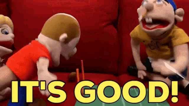a group of stuffed animals sitting on a red couch with the words " it 's good " written in yellow