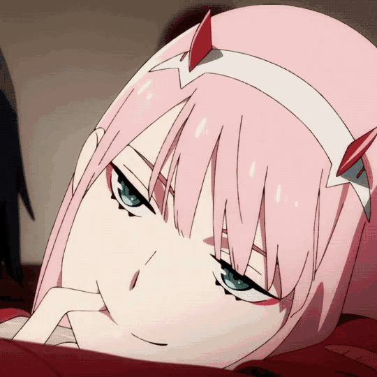 a close up of a girl with pink hair