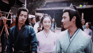 a group of people standing in front of a building with chinese characters on the bottom right corner