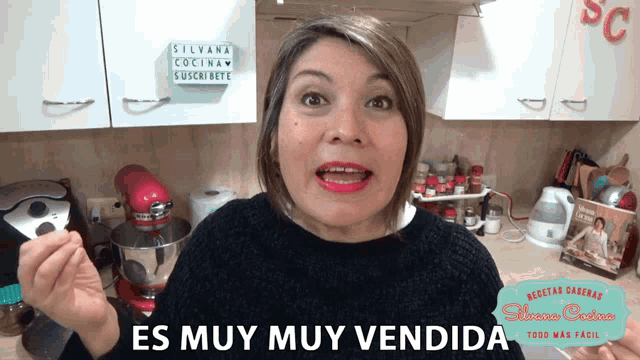 a woman in a kitchen with a sign that says silvana cocina