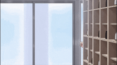 a person peeking out of a window in a room