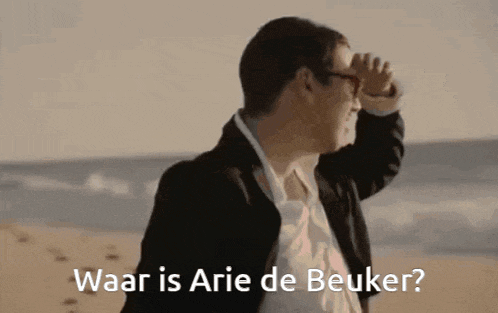 a man standing on a beach with the words waar is arie de beuker