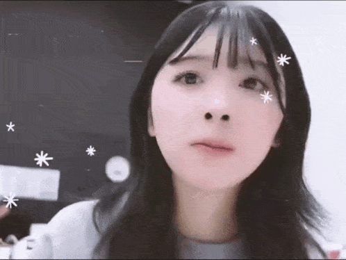 a close up of a girl 's face with stars on it