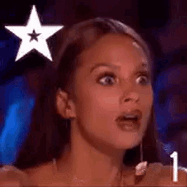 a close up of a woman 's face with a star on her head .