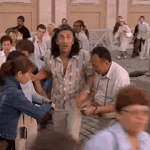 a man in a shirt that says cccp stands in a crowd