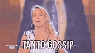 a woman is standing in front of a sign that says tanto gossip