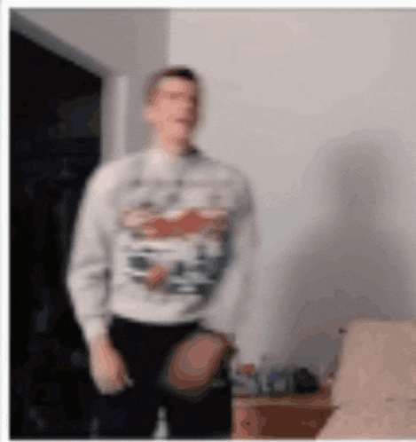a blurry photo of a man wearing a sweater