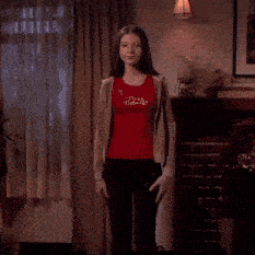 a woman wearing a red shirt that says i love dogs