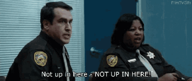 a man and a woman are sitting next to each other and the man says not up in here not up in here
