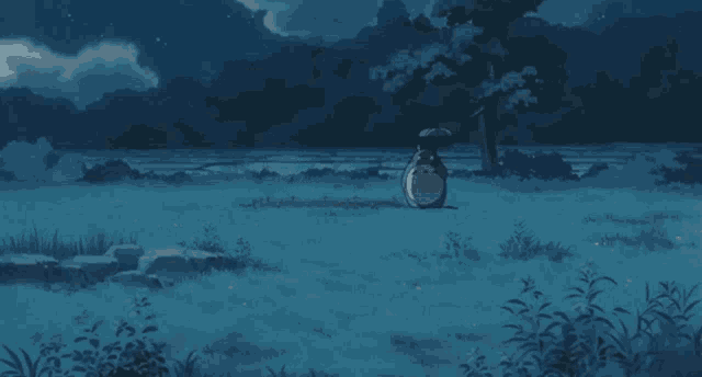 a totoro sits in a field with an umbrella